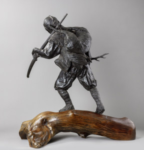 Скульптура охотника с ружьем и оленем