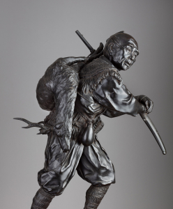 Скульптура охотника с ружьем и оленем